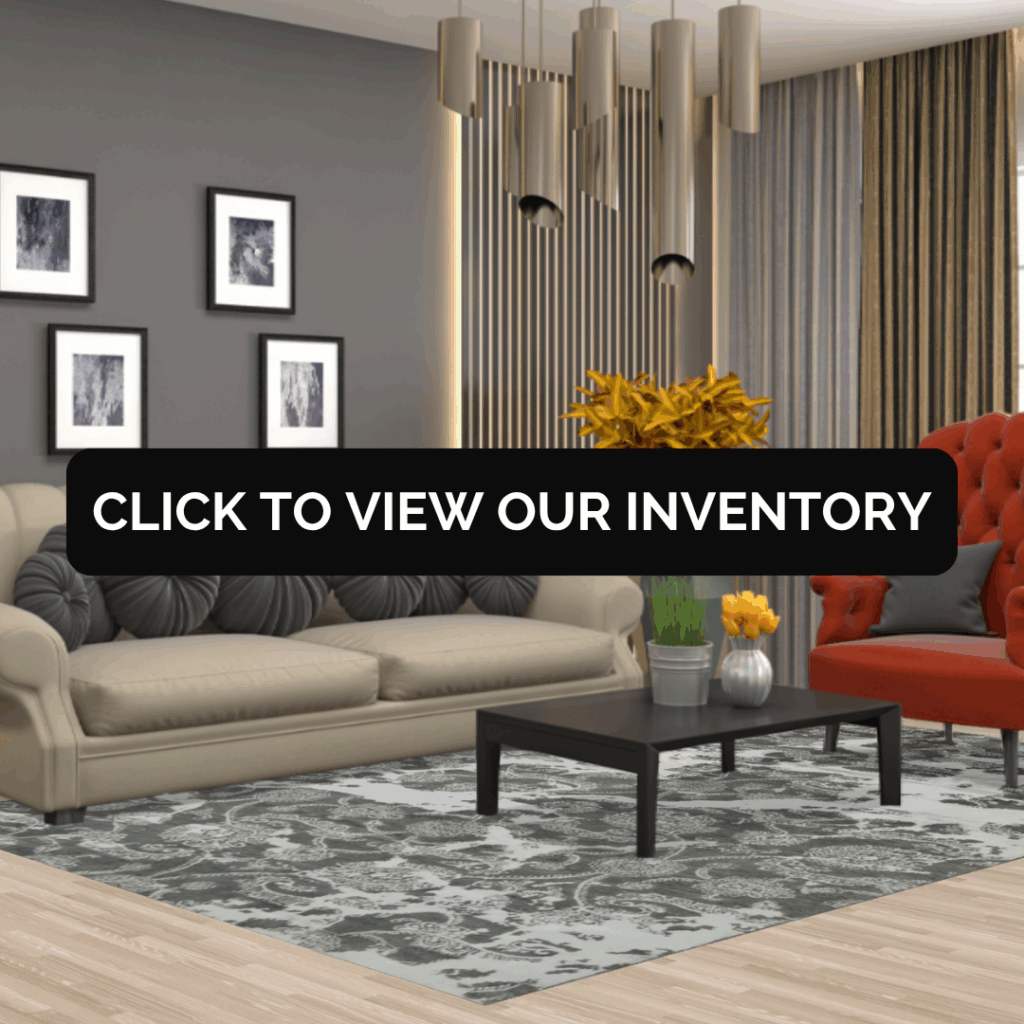 A modern living space with a beige sofa and orange armchair. The rug is a light gray design with an intricate black pattern, adding a subtle yet elegant touch. Text overlay reads “Click to view our inventory.”